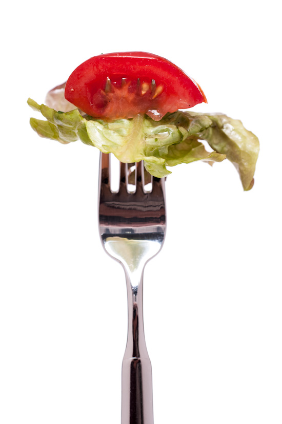 Tomato with salad on a fork